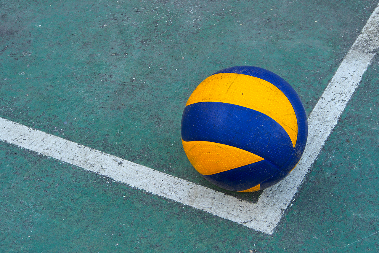 Old volleyball on a dirty court
